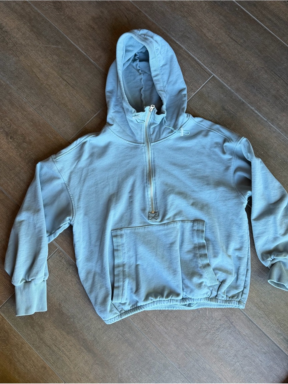 Light Blue Hooded Pullover Jacket. Cinched cropped waist and neck